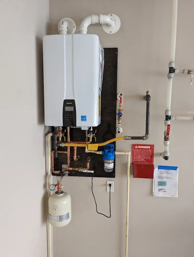 Professional plumber installing copper piping in a Sparks home